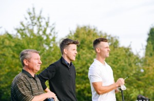 Three golf players assessing their game